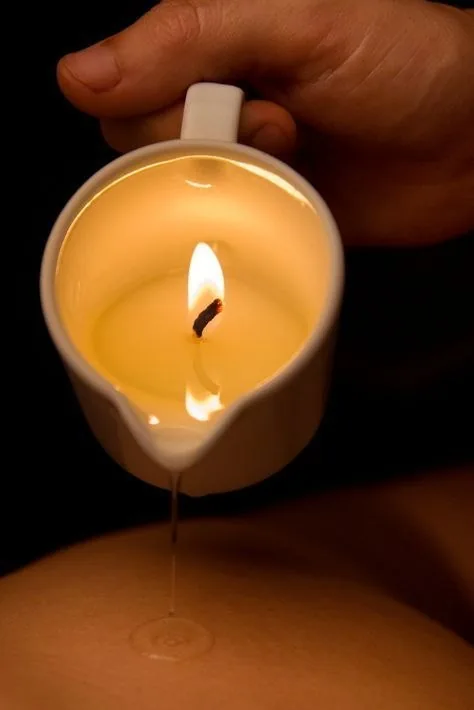 Massage candle oil poured over the back at The Port Baku Spa